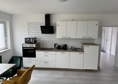 Moderne weiße Küche mit Dunstabzug in Monteurwohnung 3 in Delmenhorst